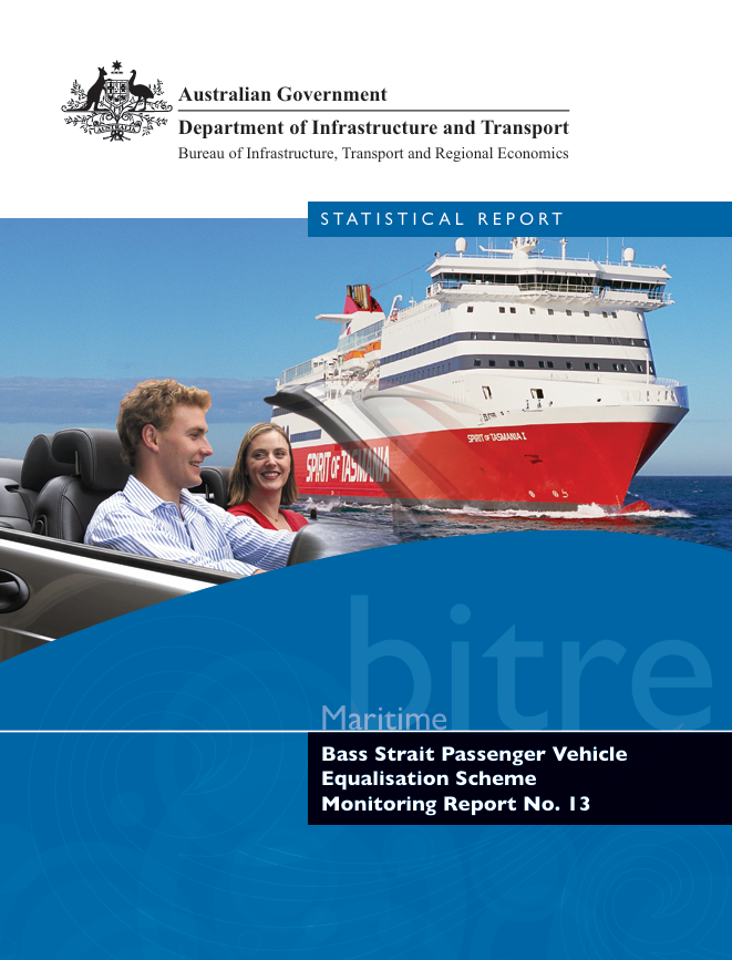 People in sports car in foreground with passenger ship in background.
