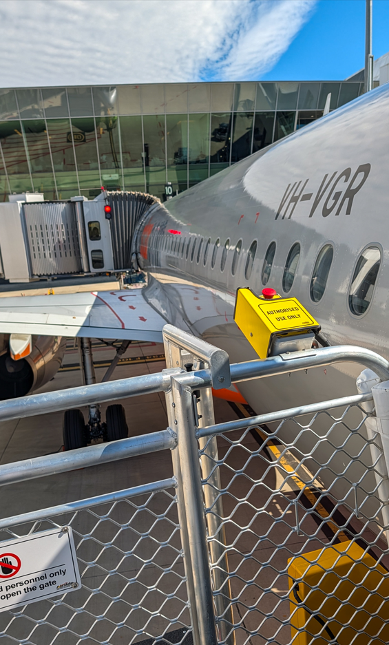 sideview of cargo plane being loaded at terminal