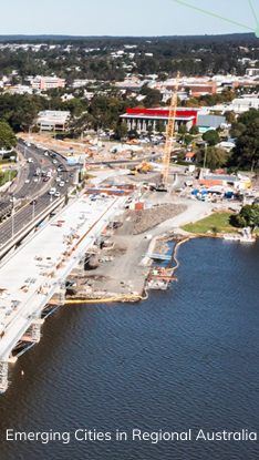 bridge and traffic with rural city in background